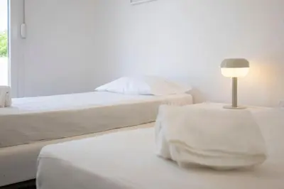 a bedroom with two beds and a lamp on a table at Centralgarve - Excellent & Peaceful Villa in the Center of Vilamoura in Vilamoura