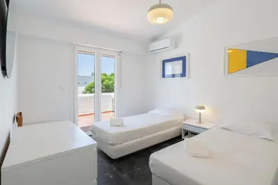 a white room with two beds and a window at Centralgarve - Excellent & Peaceful Villa in the Center of Vilamoura in Vilamoura