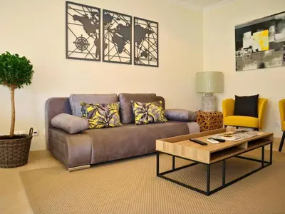 a living room with a couch and a coffee table at White 47 House by Stay ici Algarve Holiday Rental in Albufeira