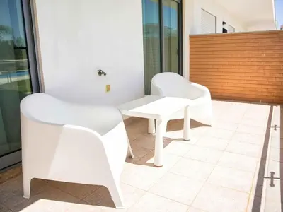 two white chairs and a table on a balcony at White 47 House by Stay ici Algarve Holiday Rental in Albufeira