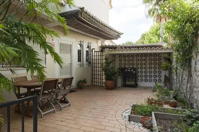 a patio with a table and chairs and a fence at Vila Caraibas - Vilamoura - by HDproperties in Vilamoura