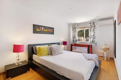 a bedroom with a large bed and a window at Casa da Saudade no centro de Faro in Faro