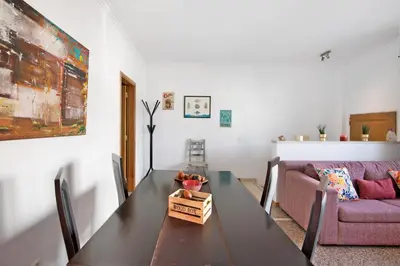 a living room with a table and a couch at Casa da Saudade no centro de Faro in Faro