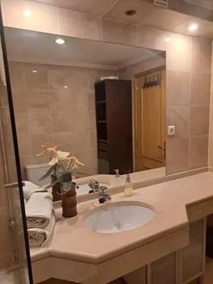 a bathroom with a sink and a large mirror at Casa da Saudade no centro de Faro in Faro