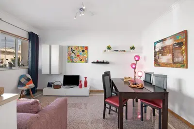 a living room with a table and a couch at Casa da Saudade no centro de Faro in Faro