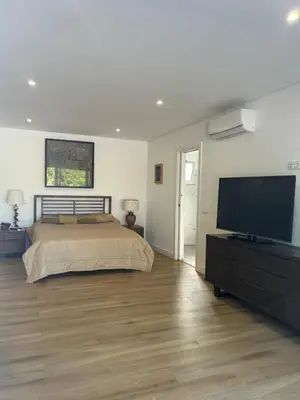 a bedroom with a bed and a flat screen tv at Quinta Verde Algarve in Medronhal