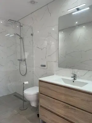 a bathroom with a toilet and a sink and a mirror at Quinta Verde Algarve in Medronhal