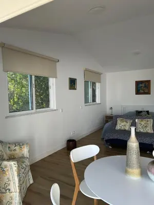 a living room with a table and a bed at Quinta Verde Algarve in Medronhal