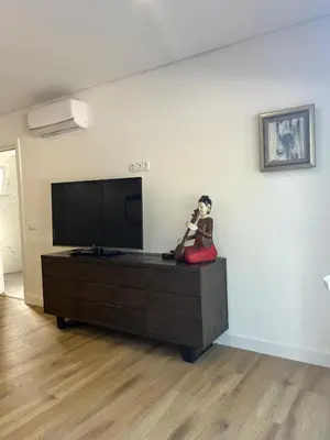 a doll sitting on a dresser in a living room at Quinta Verde Algarve in Medronhal