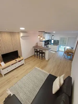 a large living room with a couch and a kitchen at Albufeira - Sun, Pool and Marina View! in Albufeira