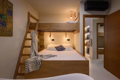 a bedroom with a bunk bed with a ladder at Maria Luisa Beach -Amaral's Guesthouses in Albufeira
