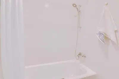 a white bathroom with a shower and a sink at Spacious 2 bedroom apartment in Faro in Faro