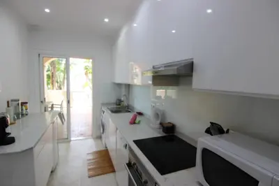 a kitchen with white counters and a large window at Los Arcos 3 - Pool & Vilamoura Center in Vilamoura