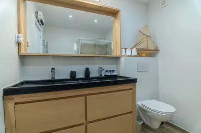 a bathroom with a sink and a toilet at Beachside Bliss T2 with Pool & Beach Access by Drago Rentals in Albufeira
