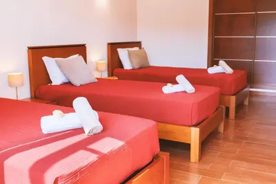 a room with three beds with white towels on them at Villa Maya Bay by Algarve Vacation in Guia