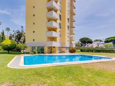 a building with a swimming pool in front of a building at AL - Apartamento Novo Horizonte in Vilamoura