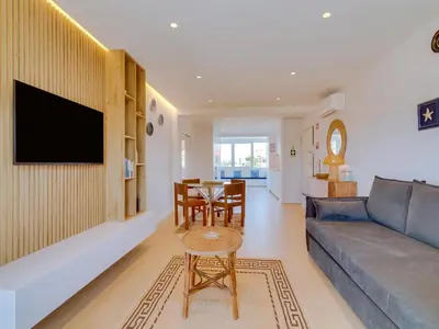 a living room with a couch and a table at AL - Apartamento Novo Horizonte in Vilamoura