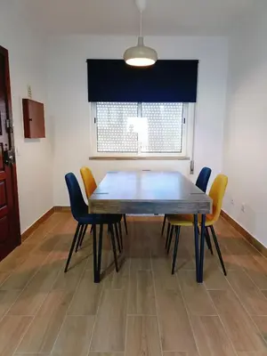 a dining room table and chairs in a room at Apartamento Praia da Gale in Albufeira