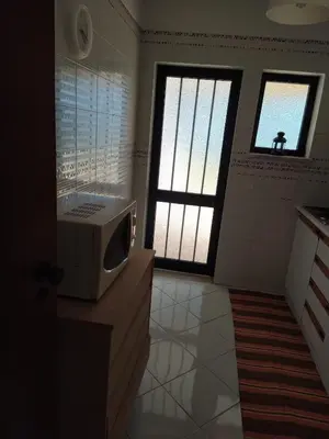 a kitchen with a microwave on top of a counter at SolNascenteII-Vilamoura in Quarteira