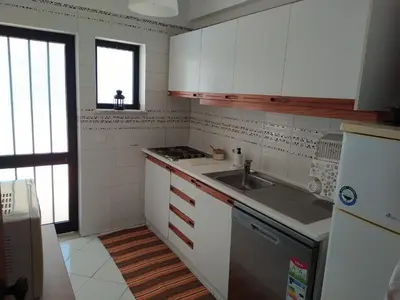 a kitchen with white cabinets and a sink at SolNascenteII-Vilamoura in Quarteira