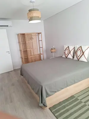 a bedroom with a large bed in a room at Apartment Center View in Faro