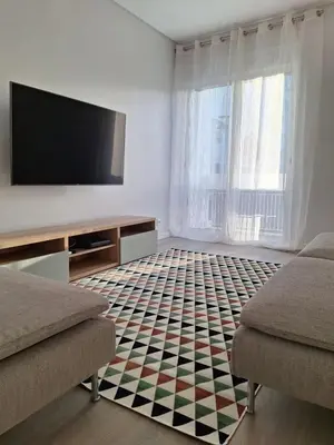 a living room with a flat screen tv and a couch at Apartment Center View in Faro