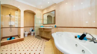 a bathroom with a tub and a toilet and a sink at Exceptional Villa with Pool, Tennis Court, Games Room in Quarteira