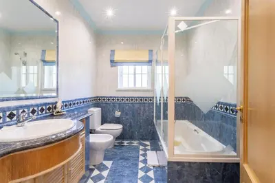 a bathroom with a tub and a toilet and a sink at Exceptional Villa with Pool, Tennis Court, Games Room in Quarteira