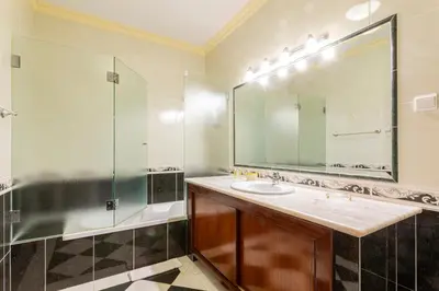 a bathroom with a sink and a shower and a mirror at Exceptional Villa with Pool, Tennis Court, Games Room in Quarteira