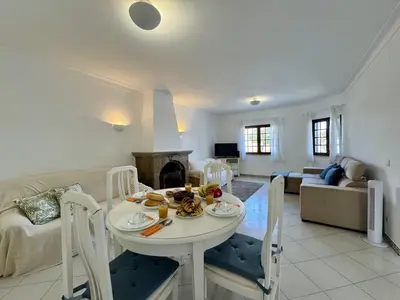 a white bathroom with a sink and a bath tub at Faro Terrace Villa by Homing in Faro