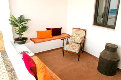 a room with a couch and a chair and a table at Monte do Couto in Albufeira