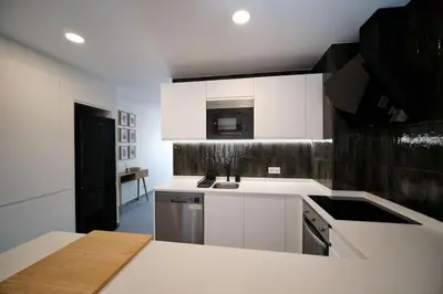 a kitchen with white cabinets and a counter top at Sea Turtle Apartment - Albufeira in Albufeira