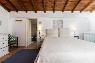 a bedroom with a large white bed in a room at NEW! 4bedroom Villa - Private Pool and Sea view in Guia