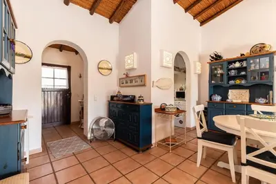 a kitchen with blue cabinets and a table at NEW! 4bedroom Villa - Private Pool and Sea view in Guia