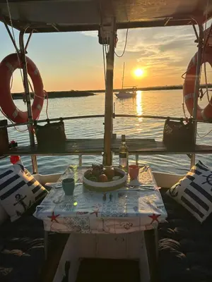 a table with a bowl of fruit on a boat at Houseboat - Faro in Ria Formosa in Faro