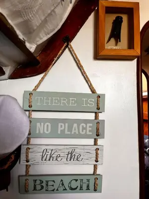 a sign that says there is no place like the beach at Houseboat - Faro in Ria Formosa in Faro