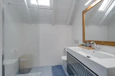 a bathroom with a sink and a toilet and a mirror at Casa do Avô - Faro City in Faro