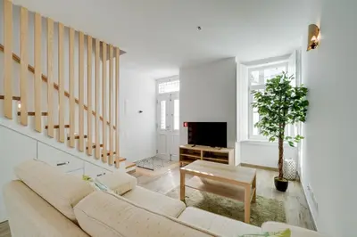 a living room with a couch and a tv at Casa do Avô - Faro City in Faro