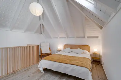 a bedroom with a large bed and a white ceiling at Casa do Avô - Faro City in Faro