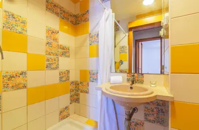 a bathroom with a sink and a mirror at Marina de Albufeira by Garvetur in Albufeira