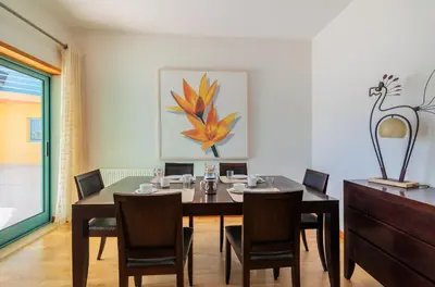 a dining room with a table and chairs at Marina de Albufeira by Garvetur in Albufeira