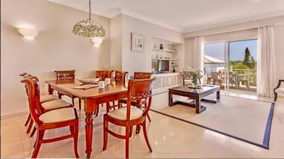 a kitchen and dining room with a table and chairs at Sandnblue - Encosta Do Lago Resort Club - Quinta do lago near Beach & lake BEST LOCATION in Quinta do Lago