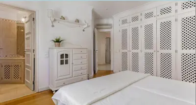 a white bedroom with a bed and a dresser at Sandnblue - Encosta Do Lago Resort Club - Quinta do lago near Beach & lake BEST LOCATION in Quinta do Lago