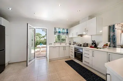 a patio with a table and chairs and a pool at 4 Bedrooms Private Pool Close To All Amenities in Quarteira