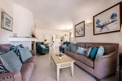 a kitchen with white cabinets and a large window at 4 Bedrooms Private Pool Close To All Amenities in Quarteira