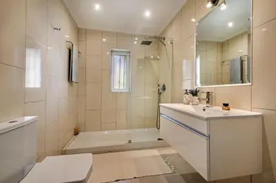 two beds in a room with a window at 4 Bedrooms Private Pool Close To All Amenities in Quarteira