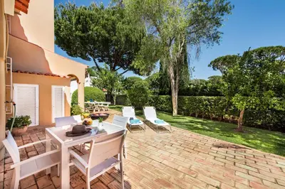 an overhead view of a swimming pool with a yellow umbrella at 4 Bedrooms Private Pool Close To All Amenities in Quarteira