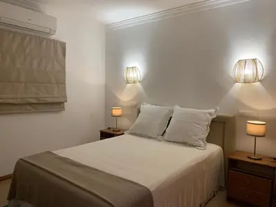 a bedroom with a bed with two lamps on it at Galé Garden House in Guia