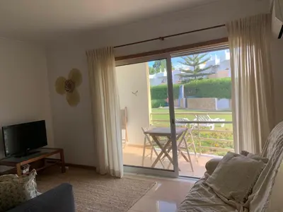 a living room with a sliding glass door to a patio at Galé Garden House in Guia
