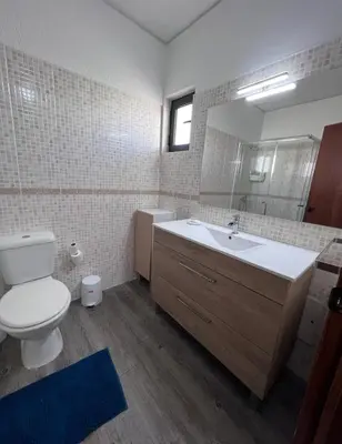 a bathroom with a toilet and a sink and a mirror at Sea View One Bedroom with Swimming Pool Ponce 282 in Albufeira